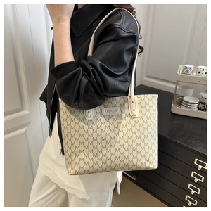 Detail of vintage monogram shoulder bag with FASHION label and sleek strap on model