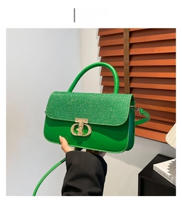 Detail of green handbag with sparkling sequins and gold CD logo buckle for women