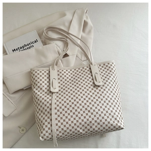 Détail d'un sac cabas minimaliste avec doubles bandoulières et imprimé géométrique
