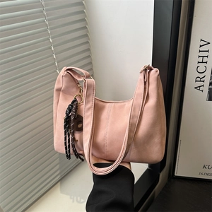 Pink crescent-shaped tote bag with woven rope detail and matte leather finish for women