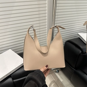 Minimalist beige leather hobo shoulder bag with silver buckle and trapezoid structure