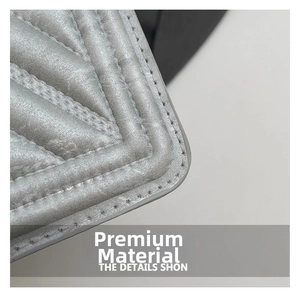 Detailed close-up of premium quilted silver-grey fabric with elegant lattice stitching