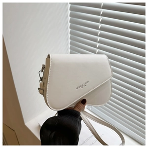 Detail of white leather crossbody bag with asymmetric flap and fashion trend logo