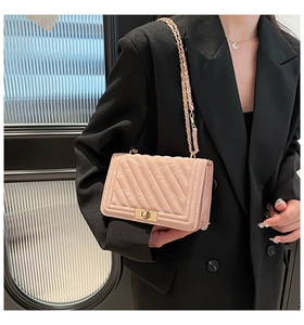 Chic quilted crossbody bag in nude pink with a golden rectangular turn-lock buckle