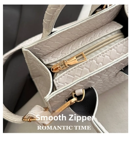 Detail shot of smooth gold zipper and white woven texture on a stylish handbag