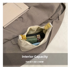 Detailed interior of minimalist off-white dumpling bag with zip closure and daily essentials