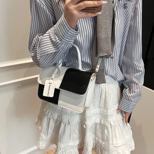 Fashionable black and white contrast handbag with top handle for summer commute
