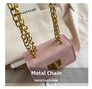 Detail of pink pebbled leather mini bag with gold chain strap and square turn-lock closure