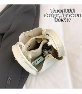 Interior view of large white leather bucket bag showing spacious storage for daily items