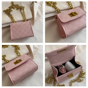 Detailed close-up of pink litchi leather mini bag with gold chain and interior space