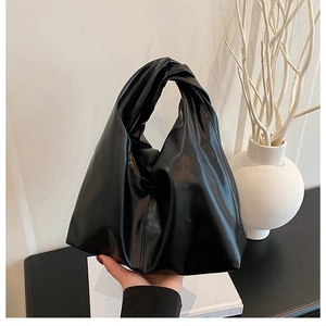 Detailansicht der schwarzen matten Ledertasche mit einzigartig verknotetem Griff-Design