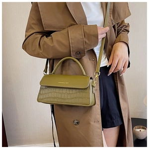 Olive green bag detail with faux crocodile texture and gold FASHION & BAG lettering