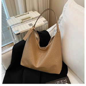Detail of light brown woven texture tote bag with fashion tag on casual background