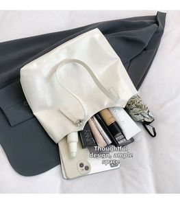 Large white glossy shoulder bag showing spacious interior with tablet and umbrella