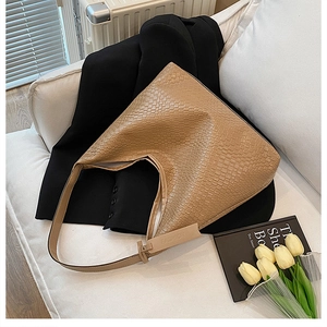 Close-up of the light brown woven texture and Fashion tag on the large tote bag