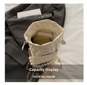 Top view of pearl chain bucket bag showing interior space for phone and wallet