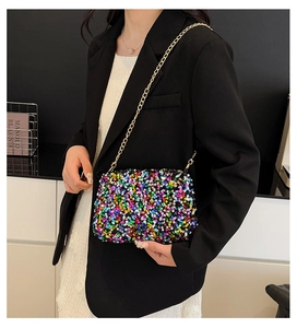 Detailed macro view of vibrant colorful sequin texture and golden metal chain of the bag