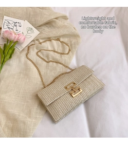 Detail of cream woven shoulder bag with V-shaped texture and gold metal chain strap