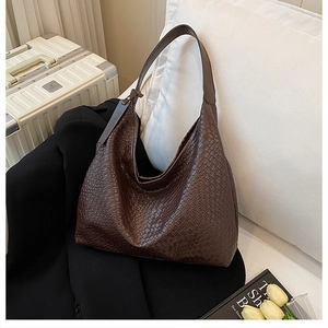 Detail of deep brown woven hobo bag with large capacity and adjustable strap for daily use