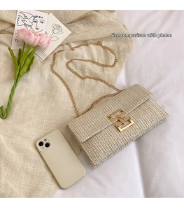 Size comparison of a beige woven chain bag with a gold buckle and smartphone next to it