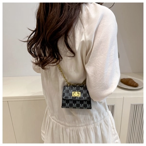 Detailed view of mini square bag with golden chain strap and letter M print pattern