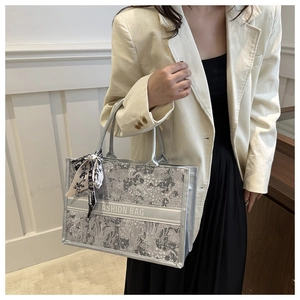 Tote bag featuring jacquard floral patterns and fashion bow silk scarf on a model