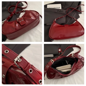 Macro shot of burgundy patent leather bag showing metal eyelet strap and interior storage