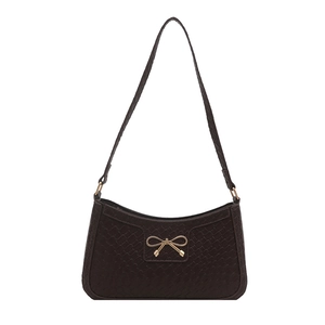 Stylish coffee brown woven crossbody bag with a golden metal bow buckle on white background