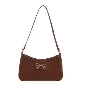 Retro dark brown woven underarm bag with a golden bow accent in crescent shape