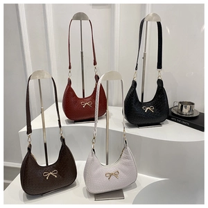 Detail of hobo shoulder bags with crocodile texture and gold bow hardware in four colors