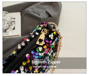 Close-up of vibrant multicolored sequins and a smooth gold zipper on a stylish crossbody bag