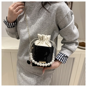 Mini black stone pattern handbag featuring elegant pearl handle and golden chain strap