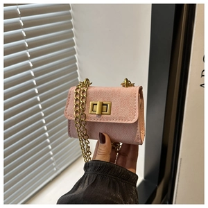 Close-up of mini pink litchi grain faux leather flap bag with gold metal square twist lock
