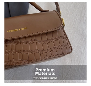 Close-up of deep brown stone texture handbag with gold Fashion and Bag lettering detail