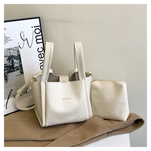 Close-up of beige litchi grain bucket bag set with inner pouch and adjustable strap