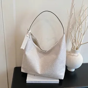 Minimalist white woven leather hobo bag with large capacity and round silhouette