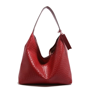 Classic red woven Hobo tote bag for women featuring a spacious design and metal buckles