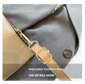 Detail of woven bag featuring adjustable brown leather strap and gold-tone metal hardware
