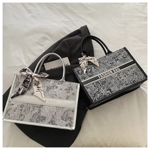 Detailed close-up of woven canvas tote bags with silk scarves and floral patterns