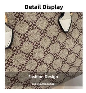 Close-up of beige woven fabric with clover pattern and precise stitching on handbag