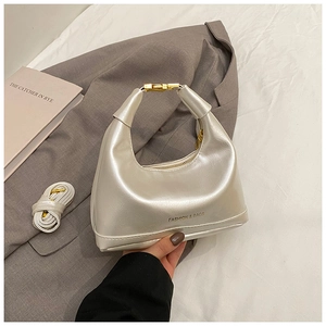 Detailed view of pearl white hobo bag with gold metal buckle and detachable shoulder strap