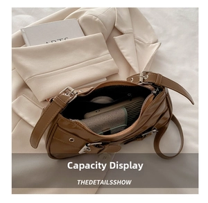 Macro shot of brown glossy hobo bag interior showing space for phone and makeup