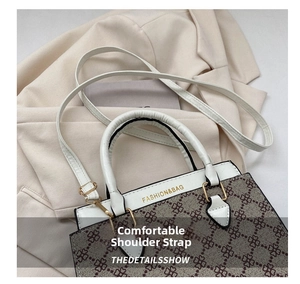 Top view of retro crossbody bag with white handles and detailed gold metal hardware