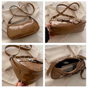 Detail view of brown crescent shoulder bag showing interior space and glossy texture