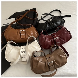 Detail of five pleated hobo bags in assorted colors with wide metallic buckles