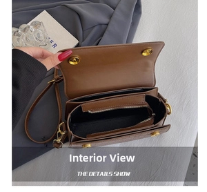 Detail shot of the brown PU leather bag interior with zipper pocket and magnetic buckle
