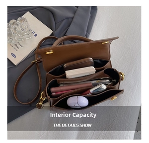 Interior view of brown stone pattern crossbody bag showing three compartments and zipper