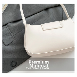 Close-up of minimalist cream white shoulder bag with smooth leather texture and neat stitching