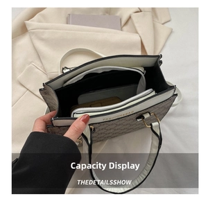 Top view of tote bag interior showing multiple compartments with phone and wallet