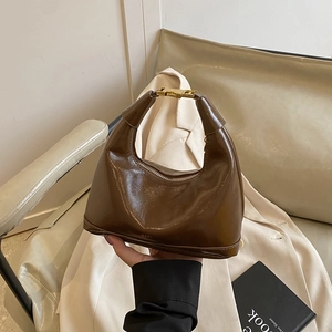 Caramel vintage semi-circle hobo bag in glossy oil wax leather with gold buckle